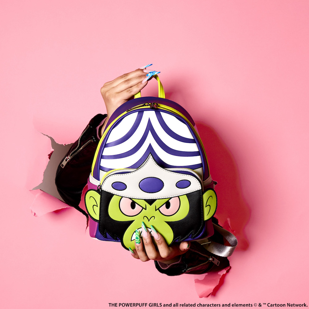 Two hands holding the Mojo Jojo Cosplay Backpack bursting through a pink background